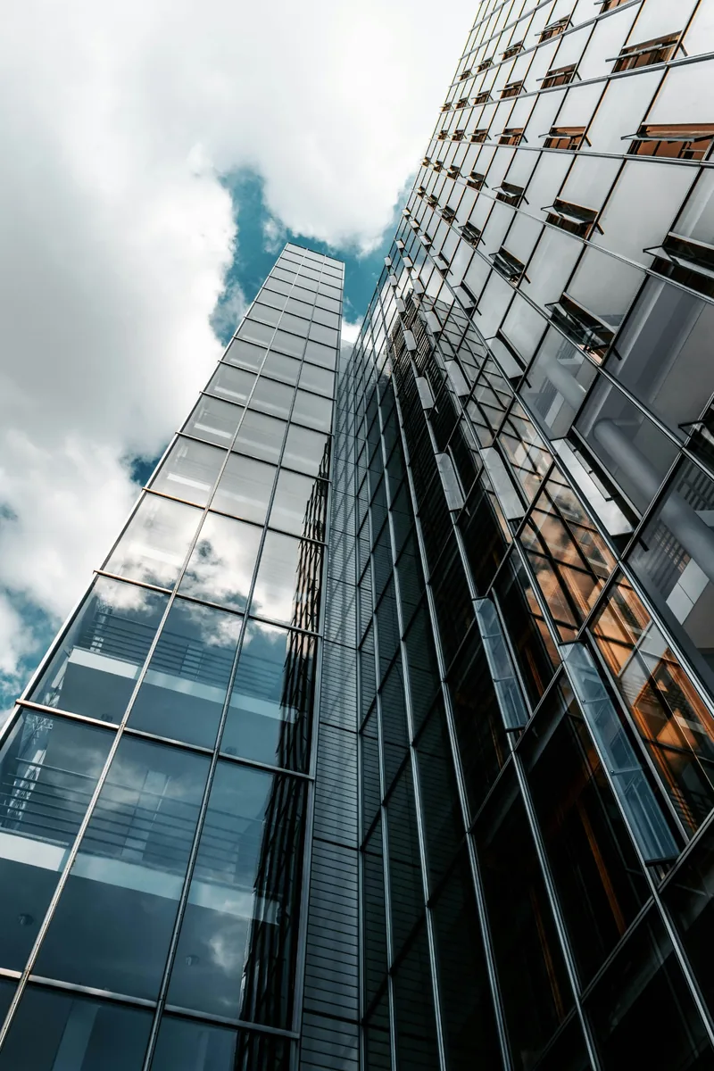 A view upward between contemporary office buildings.