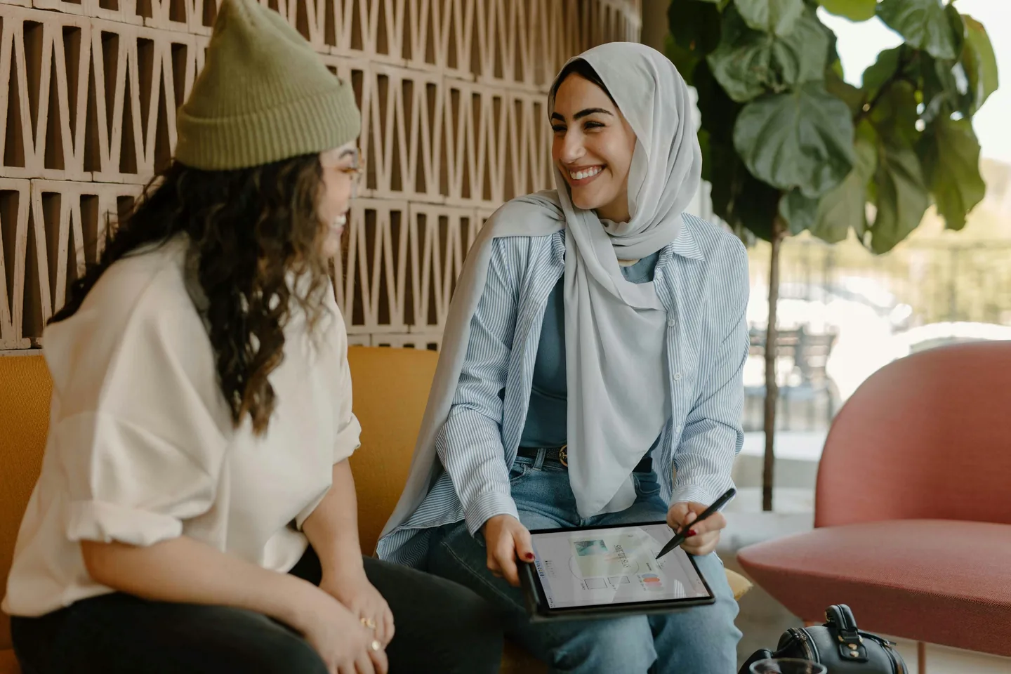Two professionals talking in a shared workspace.