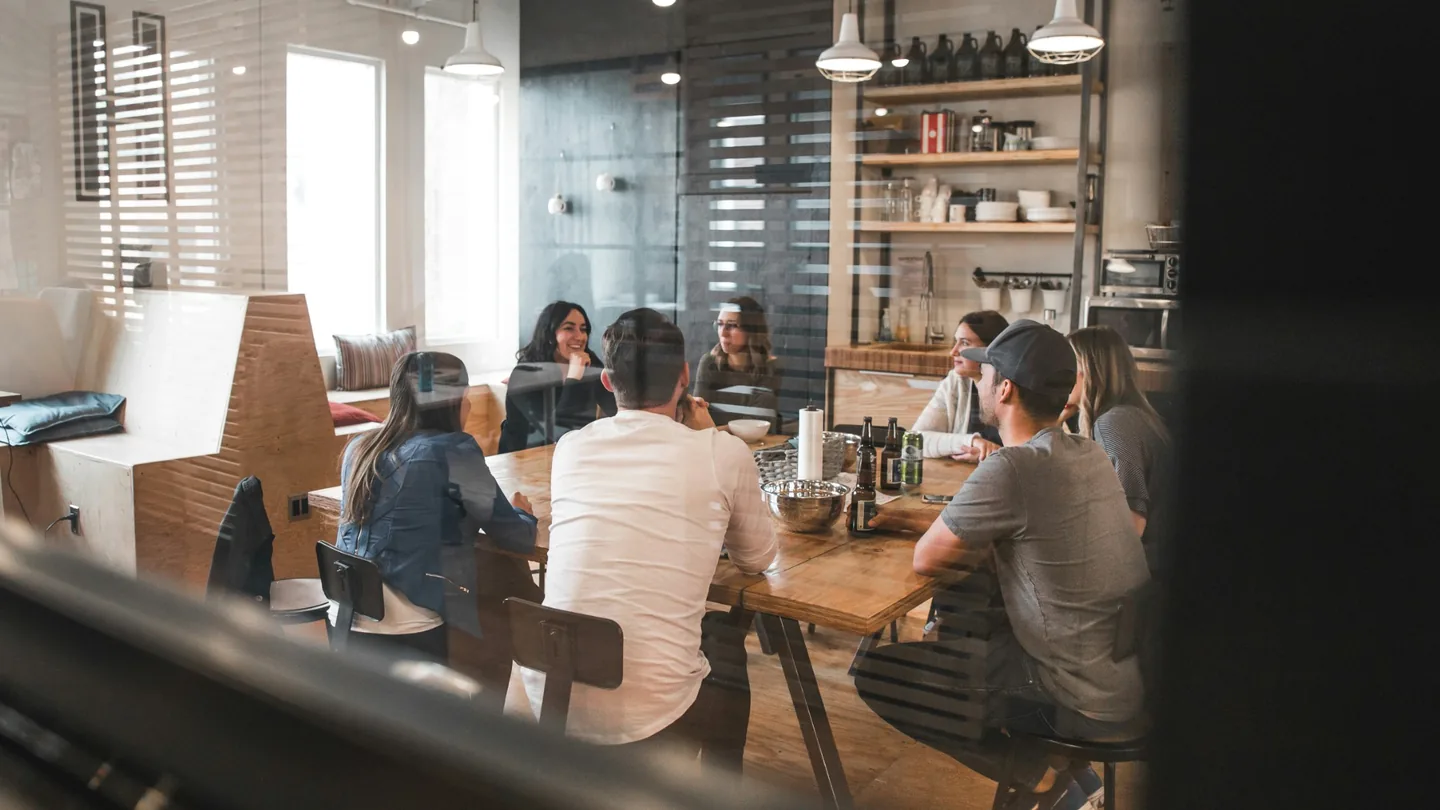 Colleagues meeting around a table in an office.